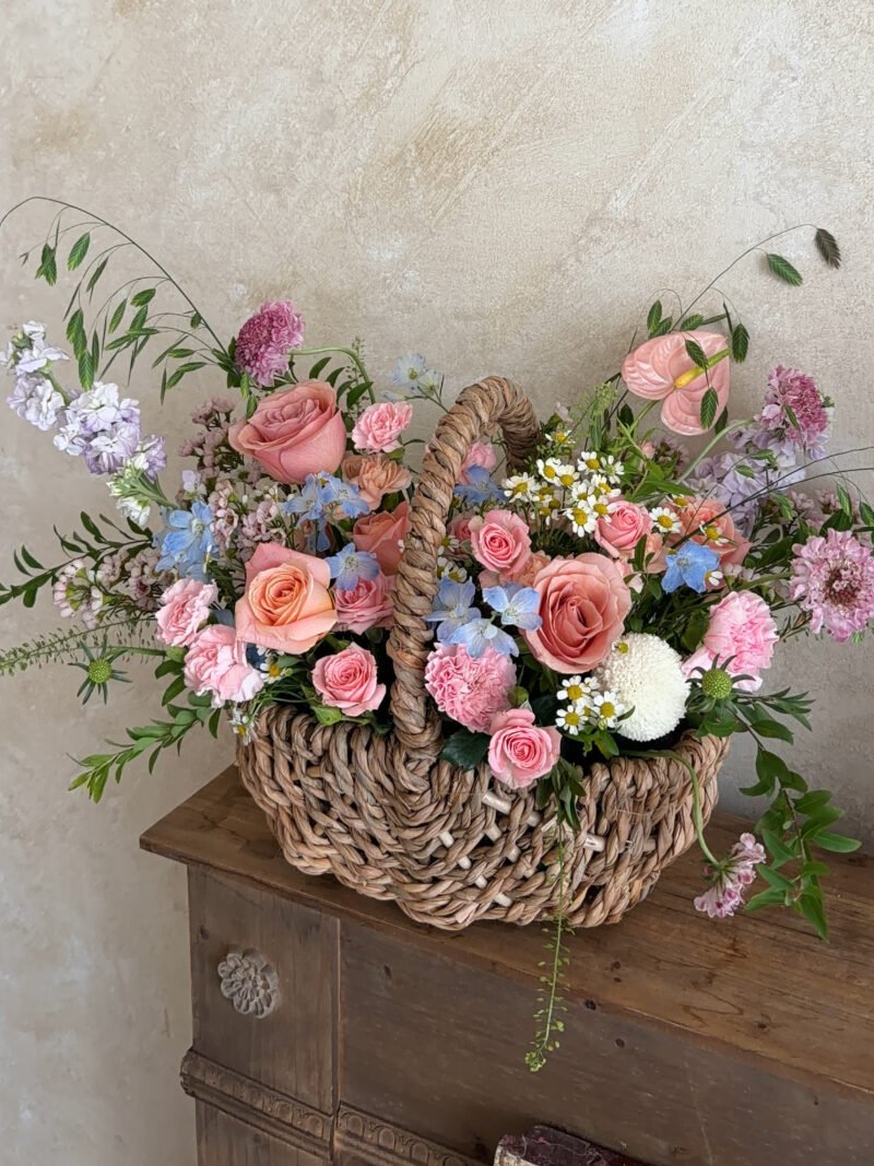 Full view of the Rosy Skies flower basket with pink roses and seasonal flowers