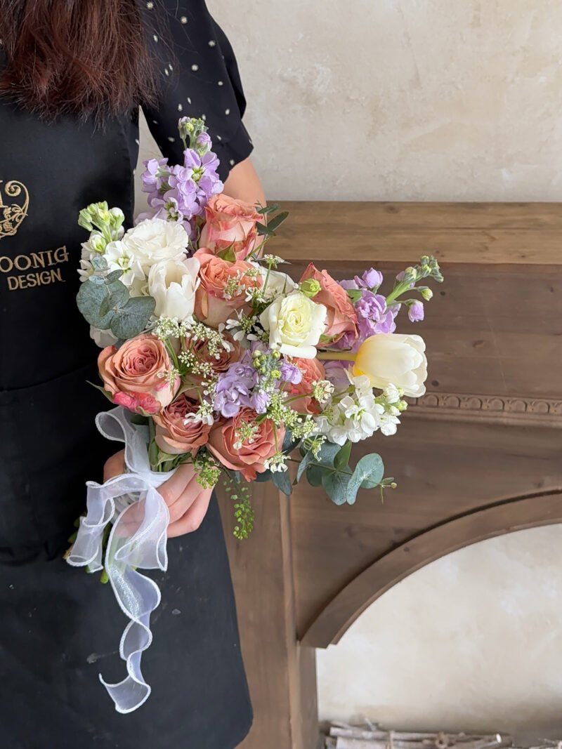 Full view of Whispering Meadow bridal bouquet in peach, white and soft lilac tones